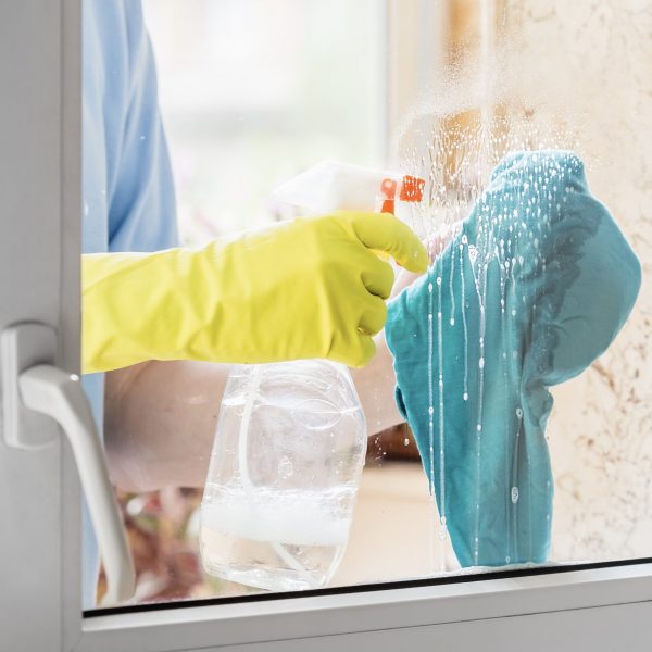 man-s-hand-cleaning-window-glass-with-liquid-clean-2023-11-27-05-04-26-utc-min